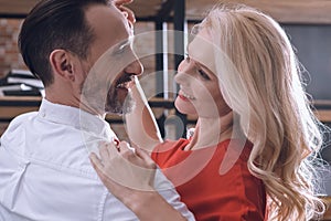 smiling happy heterosexual couple dancing at home