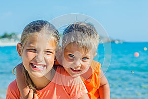 Smiling happy kids on the beach