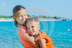 Smiling happy kids on the beach