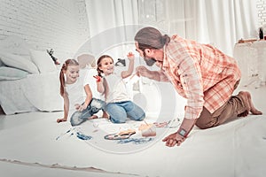 Smiling and happy kids drawing with their dad photo