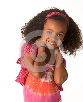 Smiling happy little girl with beautiful frizzy hair.