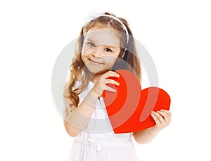 Smiling happy little girl with big red paper heart