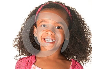 Smiling happy little girl with curly frizzy hair