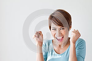 Smiling, happy, positive, excited woman on plain background