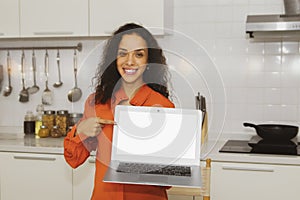 Smiling happy Spanish beautiful woman holding a laptop PC on a white background in an old rose shirt. Happy smile in the modern ki