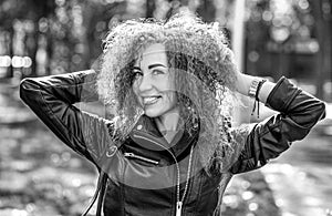 Smiling happy woman curly hair. Closeup portrait woman, girl hair, toothy smile walking in park forest outdoors. Black