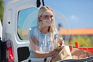 smiling happy woman enjoying shopping at supermarket