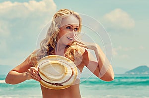 A smiling happy woman on the sea background