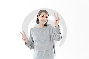 Smiling happy woman showing peace gesture with two hands