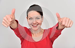 Smiling happy woman with thumbs up