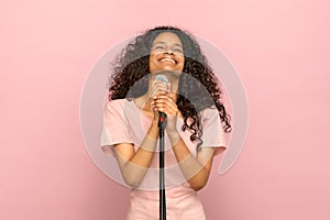 Smiling happy young black girl singing