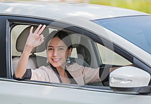 Smiling happy young woman in the car