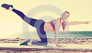 Smiling healthy female stretching muscles