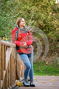 Smiling hiker resting and contemplating views in the forest.