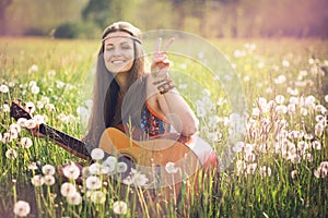 Smiling hippie woman giving peace sign