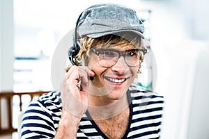 Smiling hipster businessman using headset
