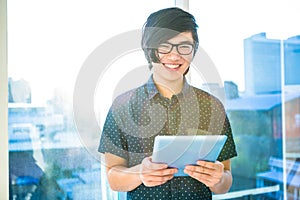 Smiling hipster businessman using tablet