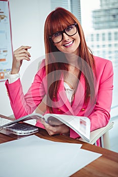 Smiling hipster businesswoman at her desk