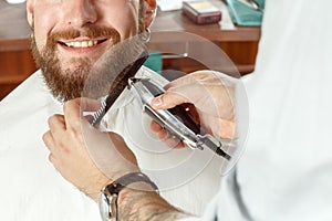 Smiling hipster during the shave