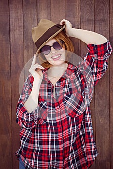 smiling hipster wearing a trilby and sunglasses