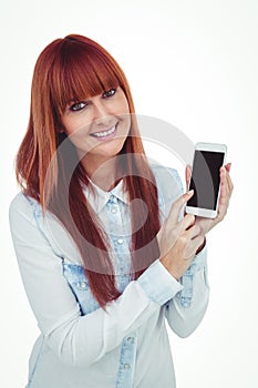 Smiling hipster woman showing her smartphone