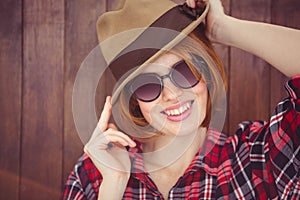 smiling hipster woman wearing a trilby and sunglasses photo