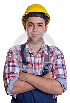 Smiling hispanic construction worker with crossed arms