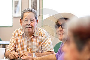 Smiling Hispanic Man in a Senior Activity Center