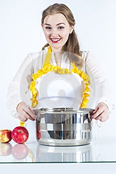Smiling homemaker with pan