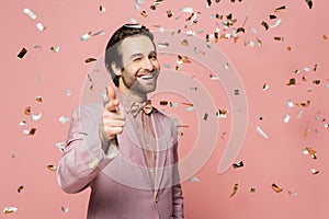 Smiling host of event pointing at