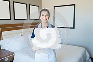 Smiling Housekeeping Woman With Clean Towels In Hotel