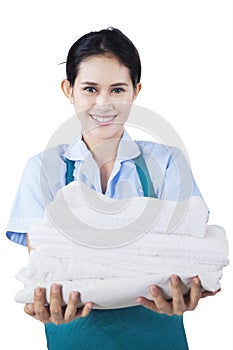 Smiling housemaid with towels