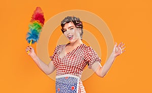 Smiling housewife hold colorful duster brush