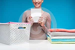 Smiling housewife with pack of washing powder