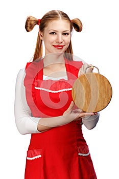 Smiling housewife in red apron with funny ponytails and wooden c