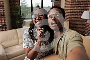 Smiling husband and wife celebrate getting house keys