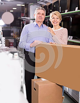 Smiling husband and wife purchased and packed appliances