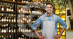 Smiling indian barman or waiter at wine bar