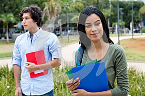 Smiling indian female student with caucasian male student