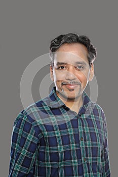 Smiling Indian Man in Casual shirt in 40s on grey background