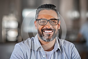 Smiling indian man looking at camera