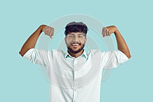 Smiling Indian man show muscles demonstrate power