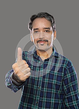 Smiling Indian Trader Man with Moustache Showing Thumbs Up on Grey Background