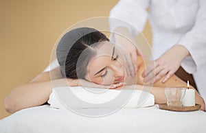 Smiling Indian Woman Enjoying Shoulders Massage In Spa Salon