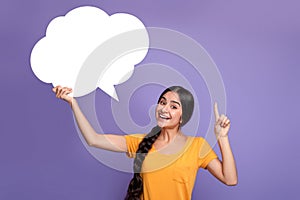 Smiling indian woman pointing finger up hoding speech bubble