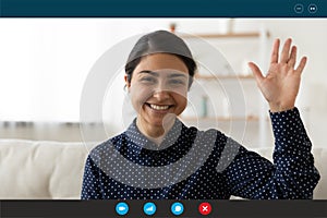 Smiling Indian woman wave talking on video call