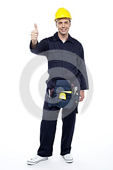 Smiling industrial engineer showing thumbs up