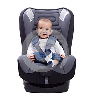 Smiling infant baby boy sitting in a car seat, isolated on white