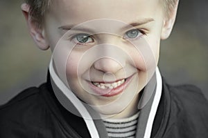 Smiling innocent kid with perfect blue eyes photo