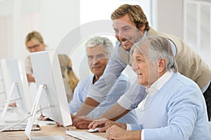 Smiling instructor with seniors in class training